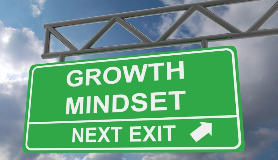 A green sign that says growth mindset next exit
